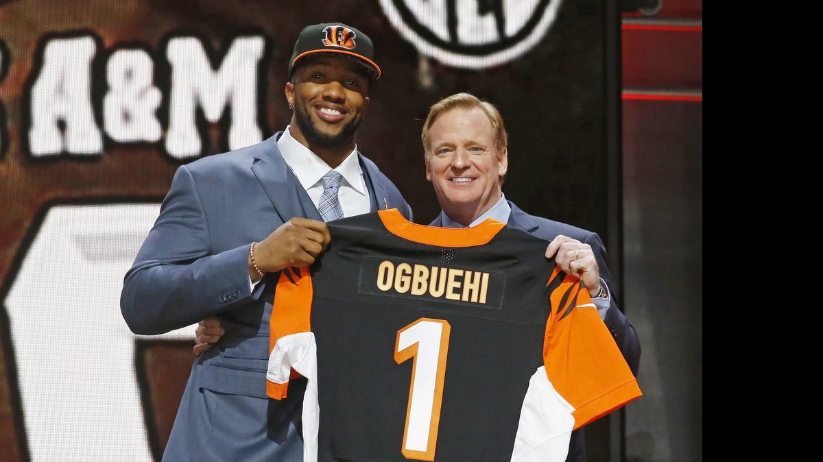 
Texas A&M offensive tackle Cedric Ogbuehi poses with NFL commissioner Roger Goodell after being selected by the Cincinnati Bengals.
