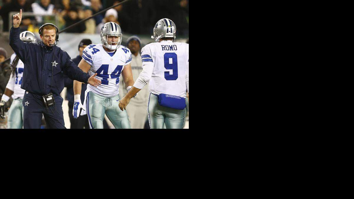 
Jason Garrett celebrates after Dallas scored Sunday. The Cowboys would host a playoff game if they win two more games.


