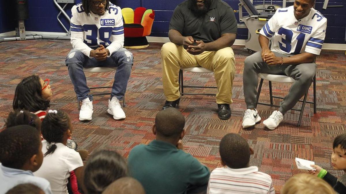 Byron Jones (31) joined Cowboys teammate Brandon Carr (39) and WWE star Mark Henry at the Salvation Army Youth Education Town in Arlington on Wednesday.