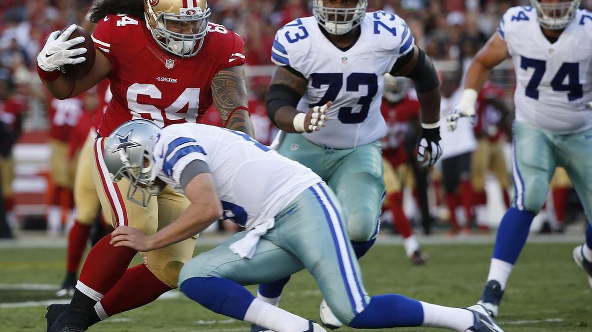 
San Francisco 49ers nose tackle Mike Purcell (64) returns an interception by Dallas Cowboys quarterback Dustin Vaughan, bottom, for a touchdown during the first half of an NFL preseason football game in Santa Clara, Calif., Sunday, Aug. 23, 2015.
