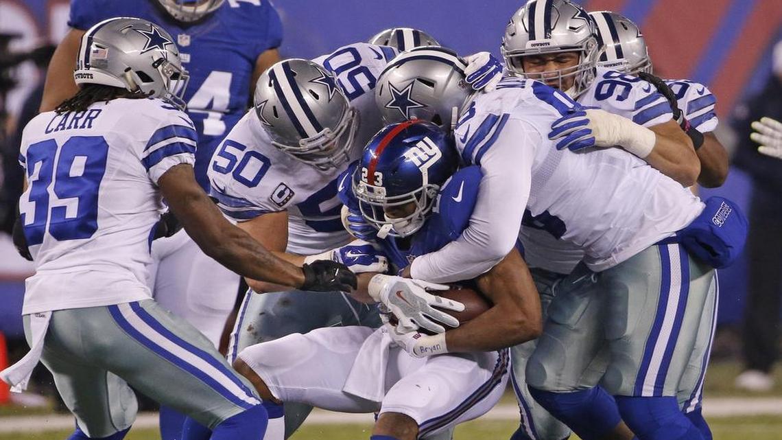 Dallas Cowboys cornerback Brandon Carr (39), outside linebacker Sean Lee (50) and defensive end Benson Mayowa (93) smother New York Giants running back Rashad Jennings (23) in Sunday’s game in East Rutherford, N.J. The Cowboys’ defense has held the last two foes to 15 and 10 points. But neither Minnesota’s offense nor the Giants’ offense is highly regard.