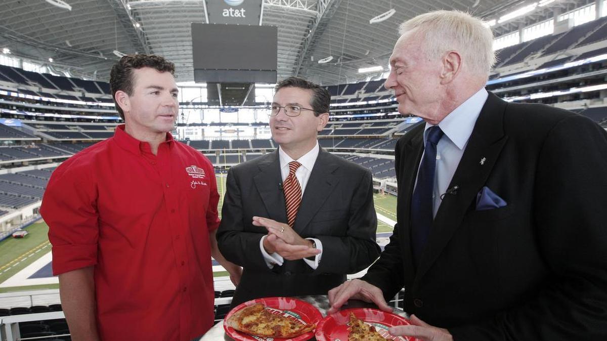 Papa John’s founder John Schnatter chats with Redskins owner Dan Snyder and Cowboys owner Jerry Jones during a commercial shoot in 2010. Papa John’s is offering Cowboys’ fans 50 percent off online orders if the team scores at least 20 points the day every game this season.