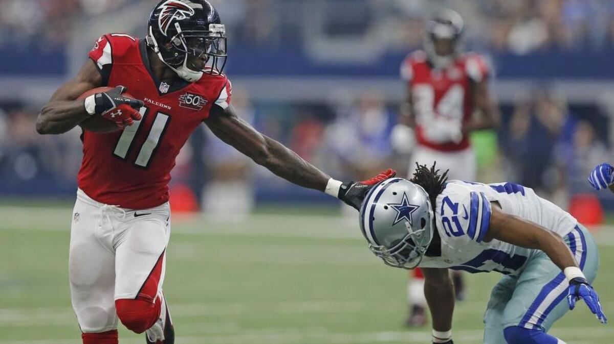 
Atlanta Falcons wide receiver Julio Jones (11) stiff arms Dallas Cowboys free safety J.J. Wilcox (27) on his way to a third quarter touchdown as the Atlanta Falcons defeat the Dallas Cowboys 39-28 in AT&T Stadium in Arlington, Texas.
