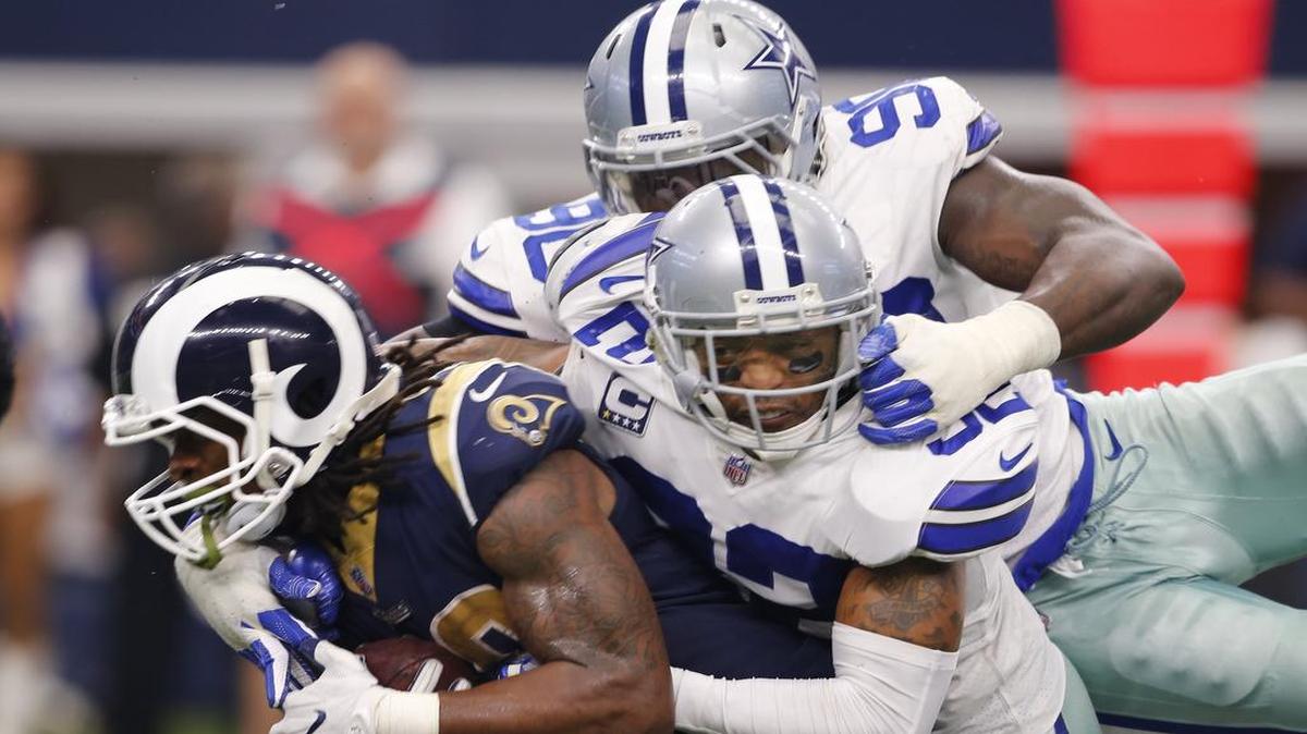 Demarcus Lawrence and Orlando Scandrick team up to tackle Los Angeles Rams running back Todd Gurley.