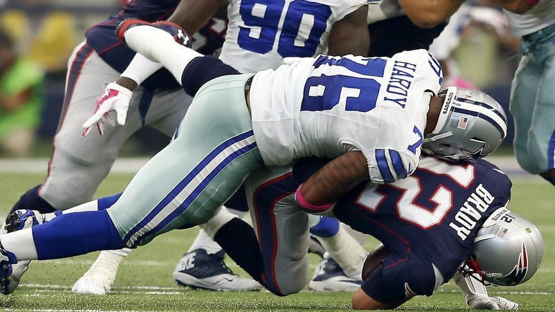 Dallas Cowboys defensive end Greg Hardy (76) sacks New England Patriots quarterback Tom Brady (12) during the first half on Sunday, Oct. 11, 2015, at AT&T Stadium in Arlington.