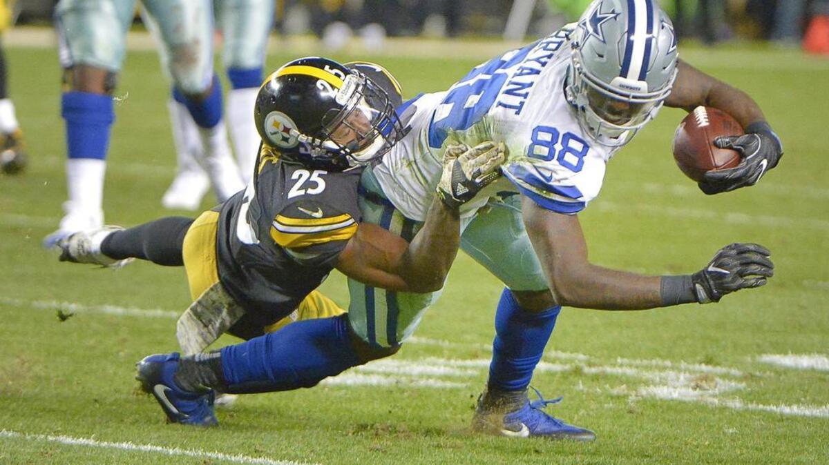 Cowboys receiver Dez Bryant battles for extra yards against Steelers cornerback Artie Burns. Bryant finished with six receptions for 116 yards and a touchdown Sunday.