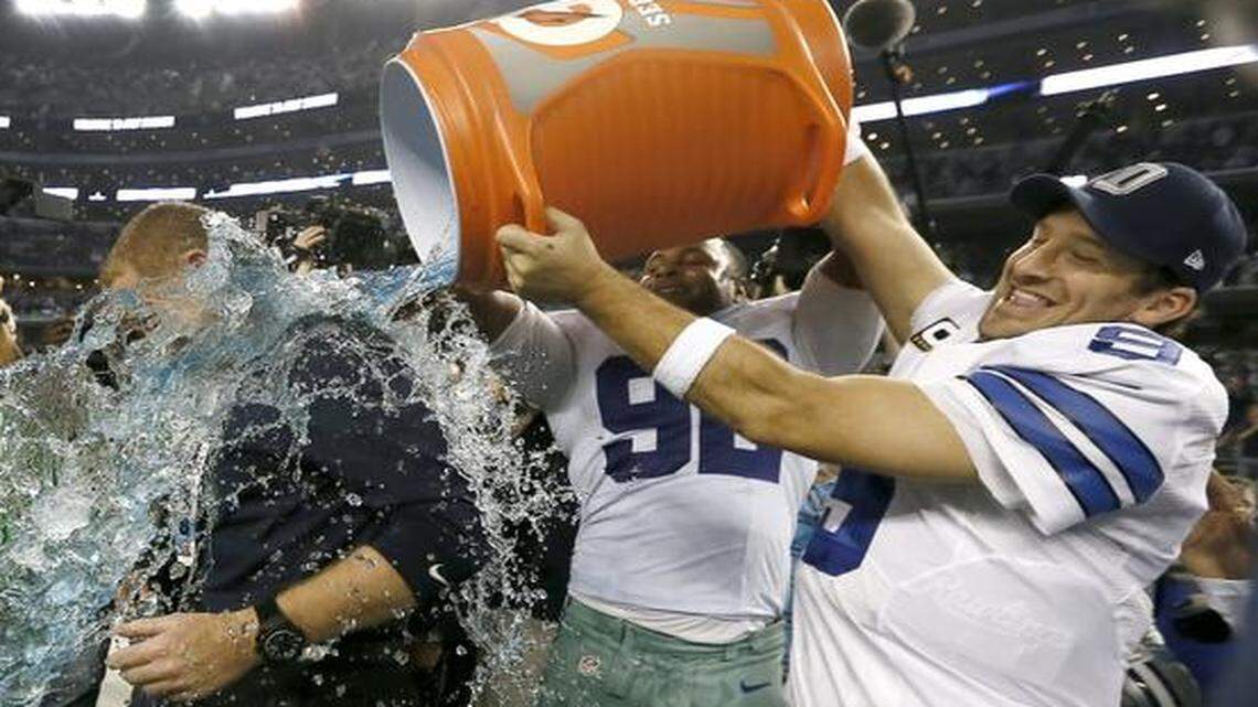 
Dallas Cowboys  coach Jason Garrett is doused by Dallas Cowboys defensive end Jeremy Mincey, middle, and quarterback Tony Romo after their 42-7 win over the Indianapolis Colts on Dec. 21 in Arlington. 
