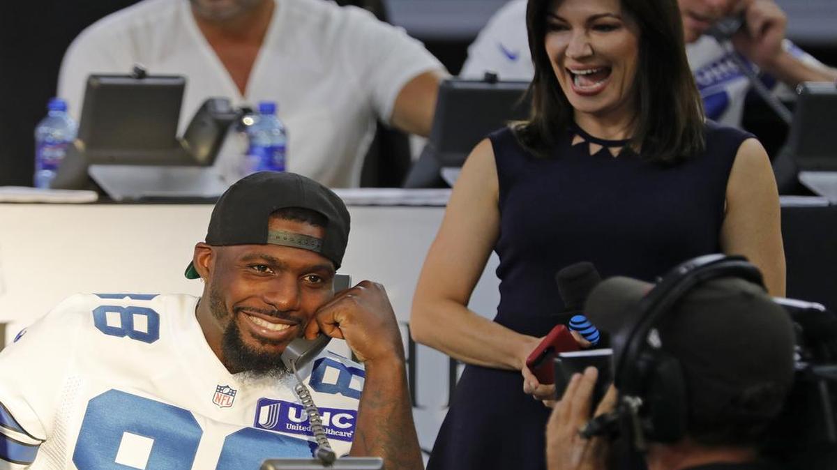 Dallas Cowboys wide receiver Dez Bryant (88) takes a million dollar donation from Jerry Jones as the Dallas Cowboys hold a telethon at AT&T Stadium to raise money for the Salvation Army efforts to provide relief to victims of Hurricane Harvey.