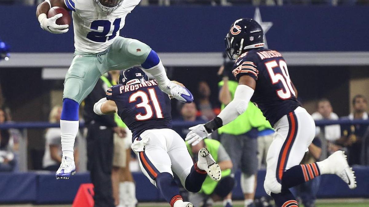 Dallas Cowboys running back Ezekiel Elliott (21) leaped over Chicago Bears safety Chris Prosinski (31) on Sunday.