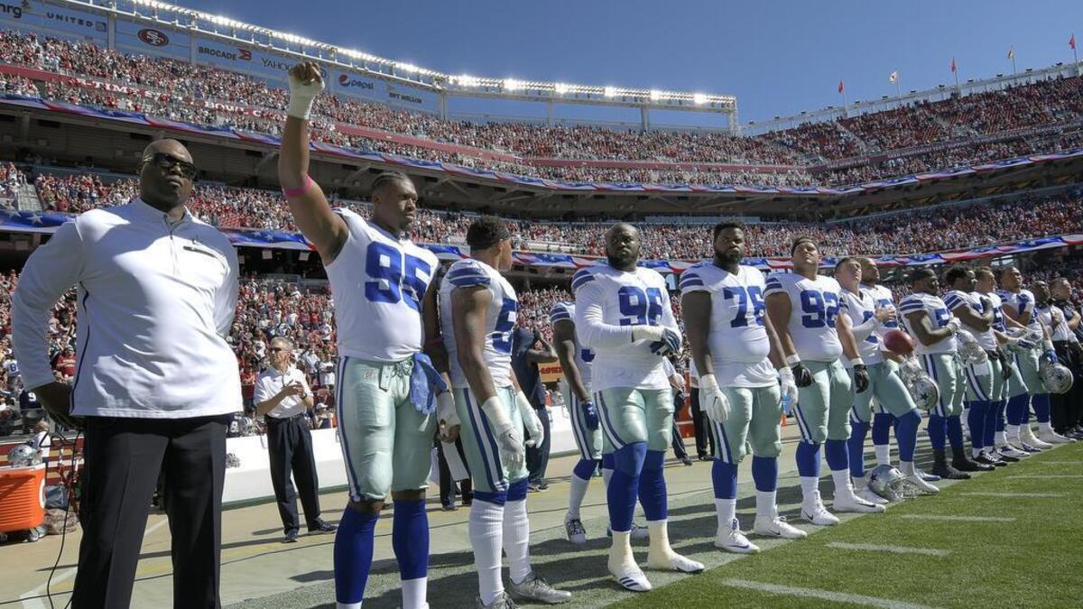 Dallas Cowboys defensive tackle David Irving raises his fist into the air after the national anthem before Sunday’s game against the San Francisco 49ers at Levi’s Stadium.