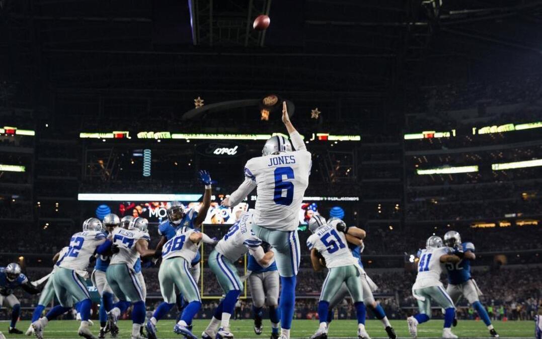 Cowboys punter Chris Jones punts the ball from deep in his own end zone late in the fourth quarter against the Lions at AT&T Stadium on December 26.