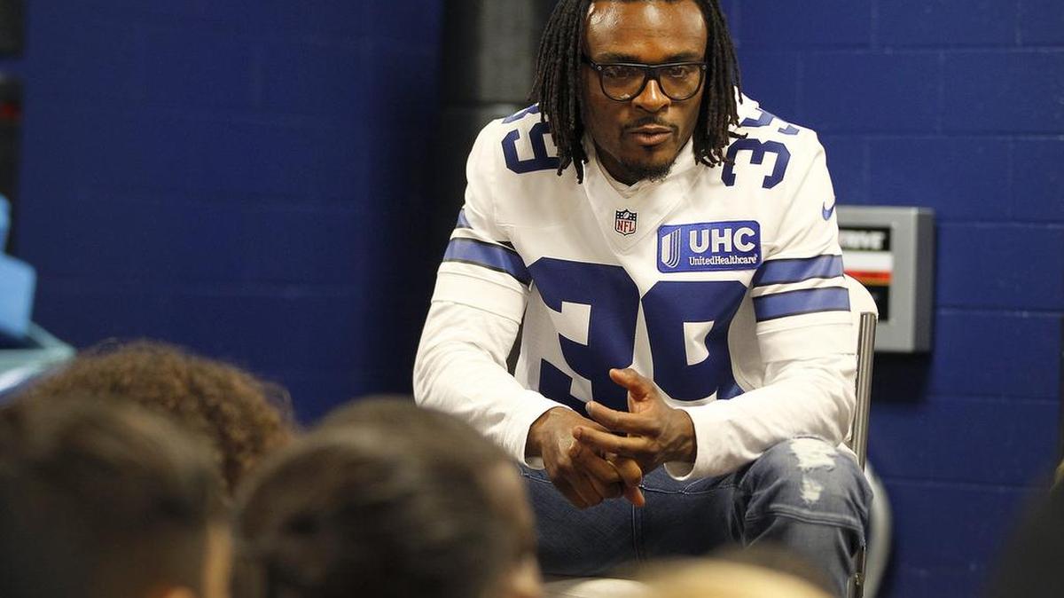 Cowboys cornerback Brandon Carr visits with kids at the Salvation Army Youth Education Town in Arlington on Wednesday.