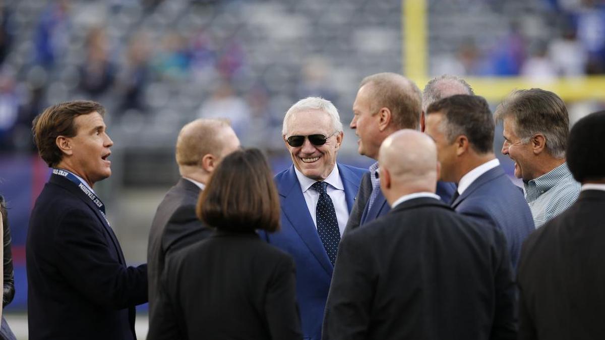 Dallas Cowboys owner Jerry Jones holding court on the field before the 27-20 loss against the New York Giants.