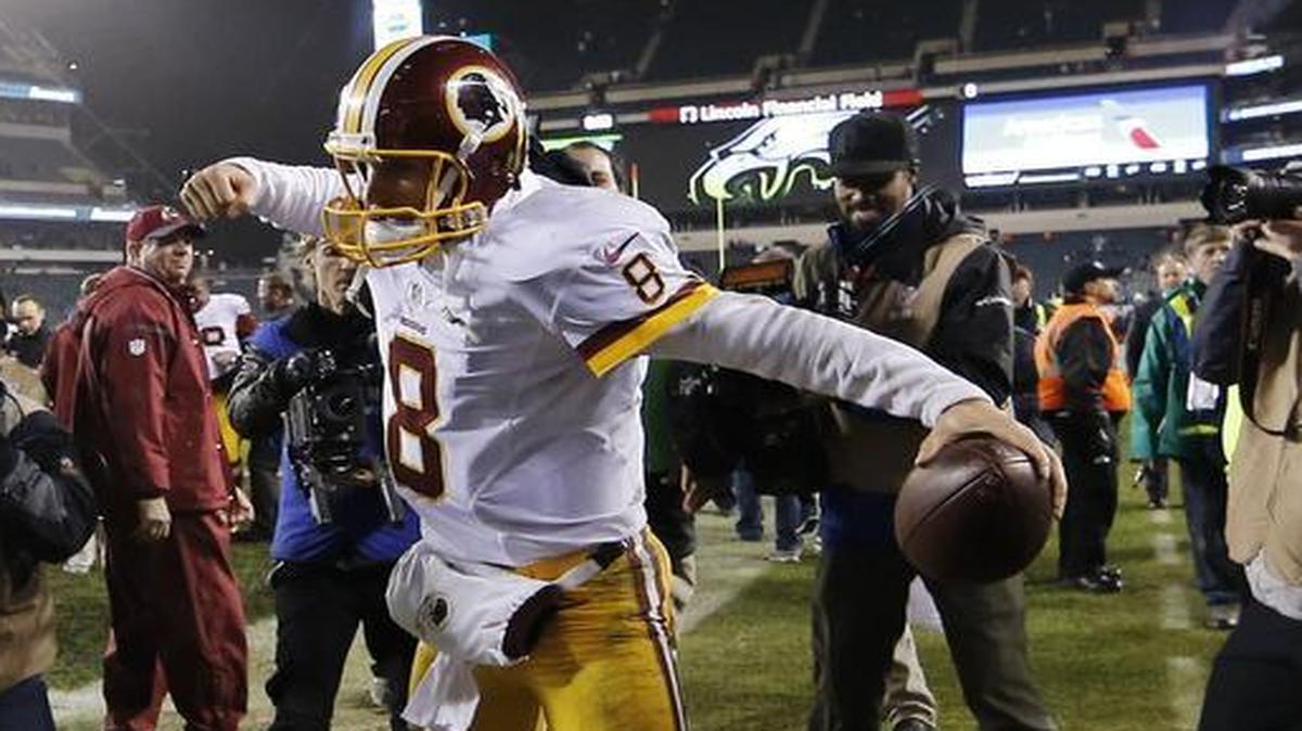 Washington Redskins quarterback Kirk Cousins celebrates as he walks off the field following a 38-24 victory in Philadelphia on Saturday that clinched the NFC East title.