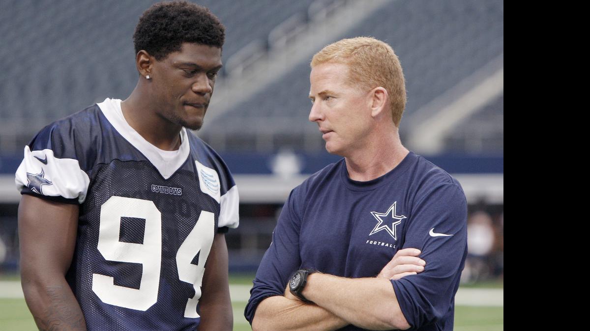
Rookie defensive end Randy Gregory chats with coach Jason Garrett during a minicamp practice at AT&T Stadium.
