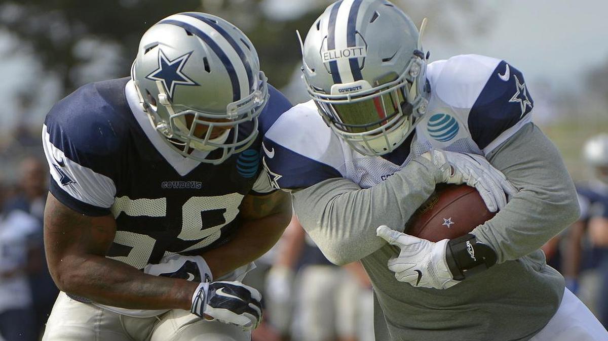 Ezekiel Elliott, right, at training camp with linebacker Anthony Hitchens, has intrigued the Cowboys with his power, instincts and ability as a complete back capable of running, catching and blocking.