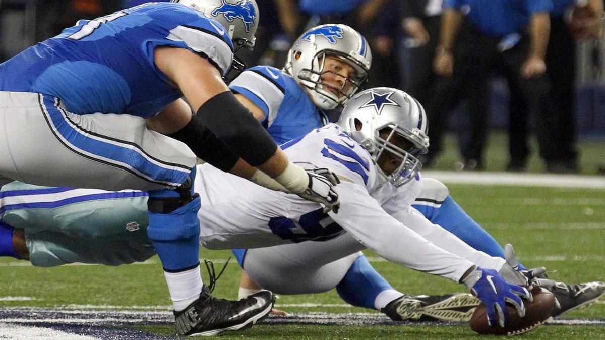 
Dallas Cowboys defensive end Demarcus Lawrence (90) grabs the ball as Detroit Lions tackle Riley Reiff (71) and quarterback Matthew Stafford (9) try to recover the fumble at the end of the fourth quarter on Sunday, Jan. 4, 2015, at AT&T Stadium. 

