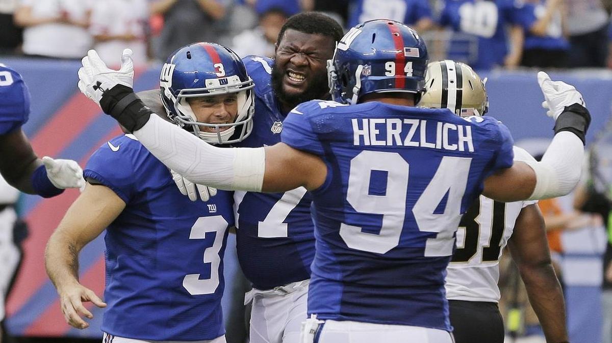 New York Giants kicker Josh Brown, left, celebrates with Mark Herzlich and John Jerry after making a winning field goal against New Orleans Sunday. The Giants are 2-0.