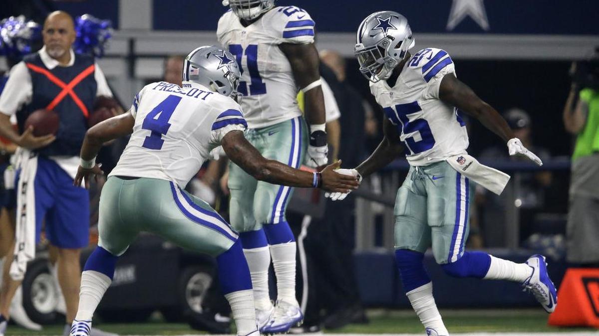 Dallas Cowboys quarterback Dak Prescott and running back Lance Dunbar celebrate Dunbar’s 1-yard touchdown.