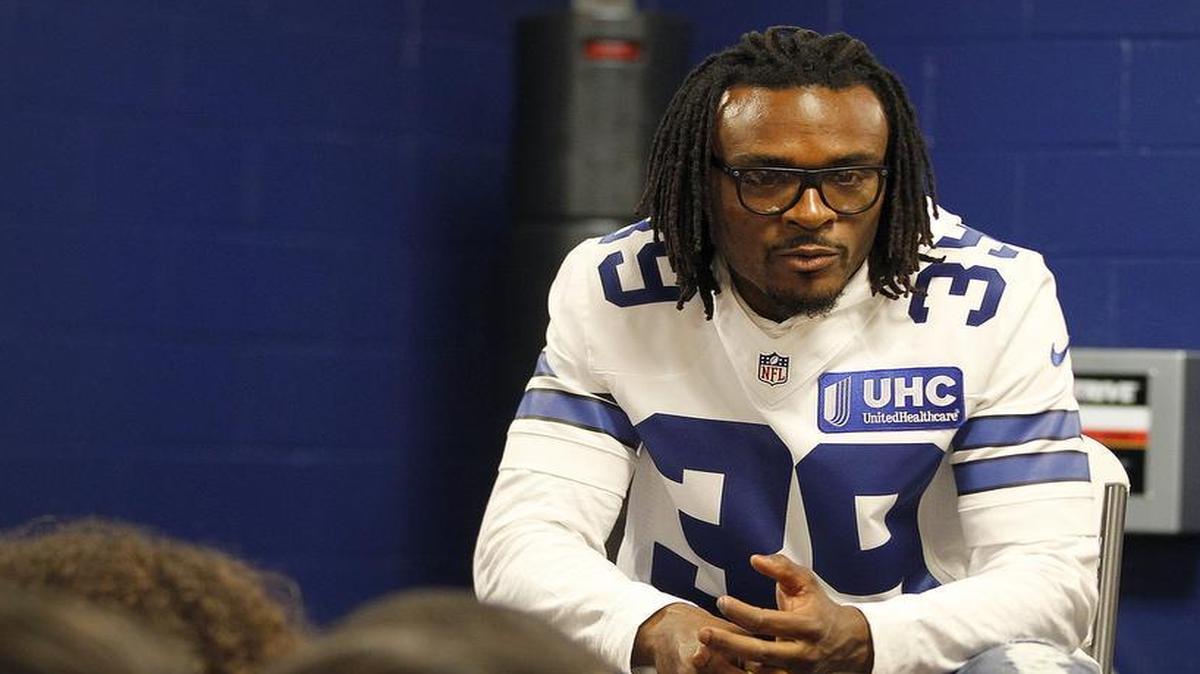 Cowboys cornerback Brandon Carr visits with kids during a joint charity appearance with WWE Superstars at the Salvation Army Youth Education Town in Arlington.