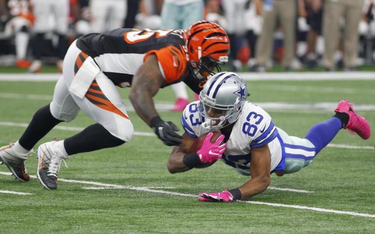 Terrance Williams dives for a first down against Bengals linebacker Vontaze Burfict, one of his five catches for 70 yards.