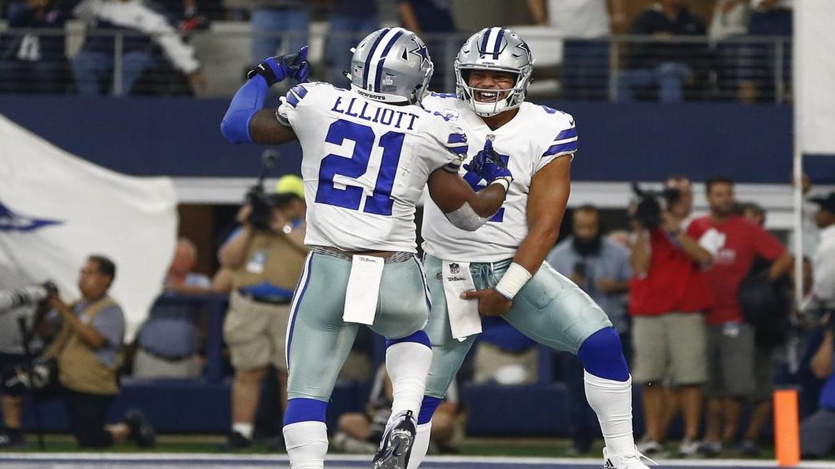 Cowboys quarterback Dak Prescott, right, celebrates a touchdown with running back Ezekiel Elliott during Sunday’s game against the Green Bay Packers.