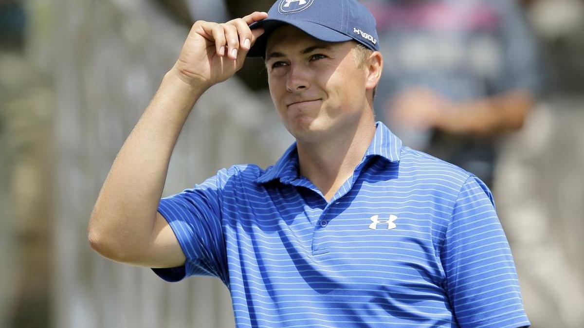 Defending Masters champion Jordan Spieth is showcased in an AT&T golf ad that also includes Dallas Cowboys quarterback Tony Romo.
