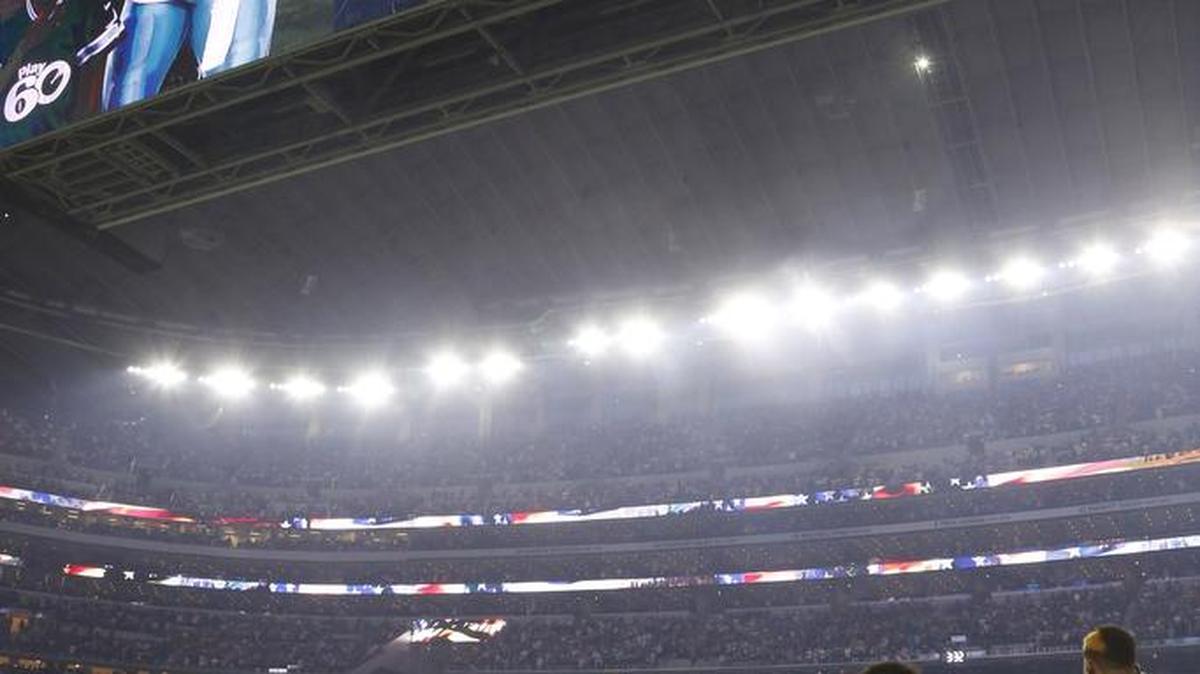 The Dallas Cowboys all stand for the National Anthem as coach Jason Garrett calls the anthem and the flag scared.