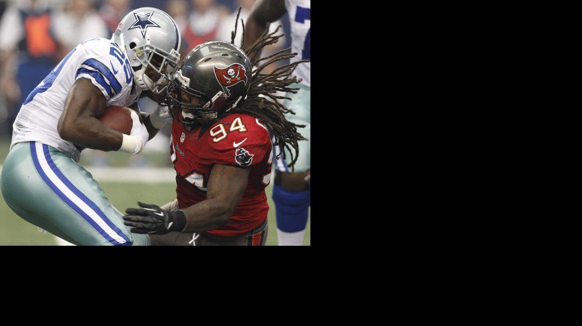 
Bucs defensive end Adrian Clayborn stuffs Cowboys running back DeMarco Murray during a 2012 game. Clayborn and Murray both are free agents. 
