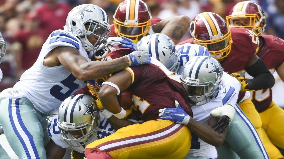 Washington Redskins tight end Niles Paul (84) is gang-tackled by Dallas Cowboys defenders during the second quarter action at FedEx Field on Sunday.