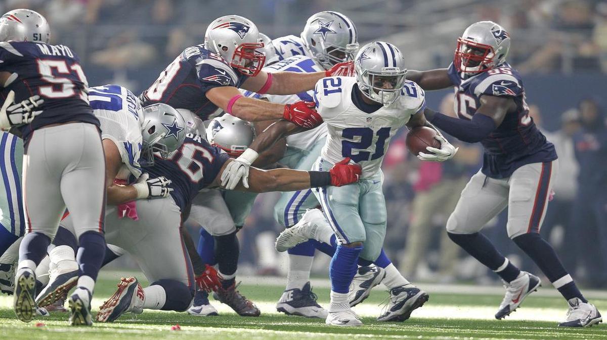 
Dallas Cowboys running back Joseph Randle slips through a crease in the New England defense.
