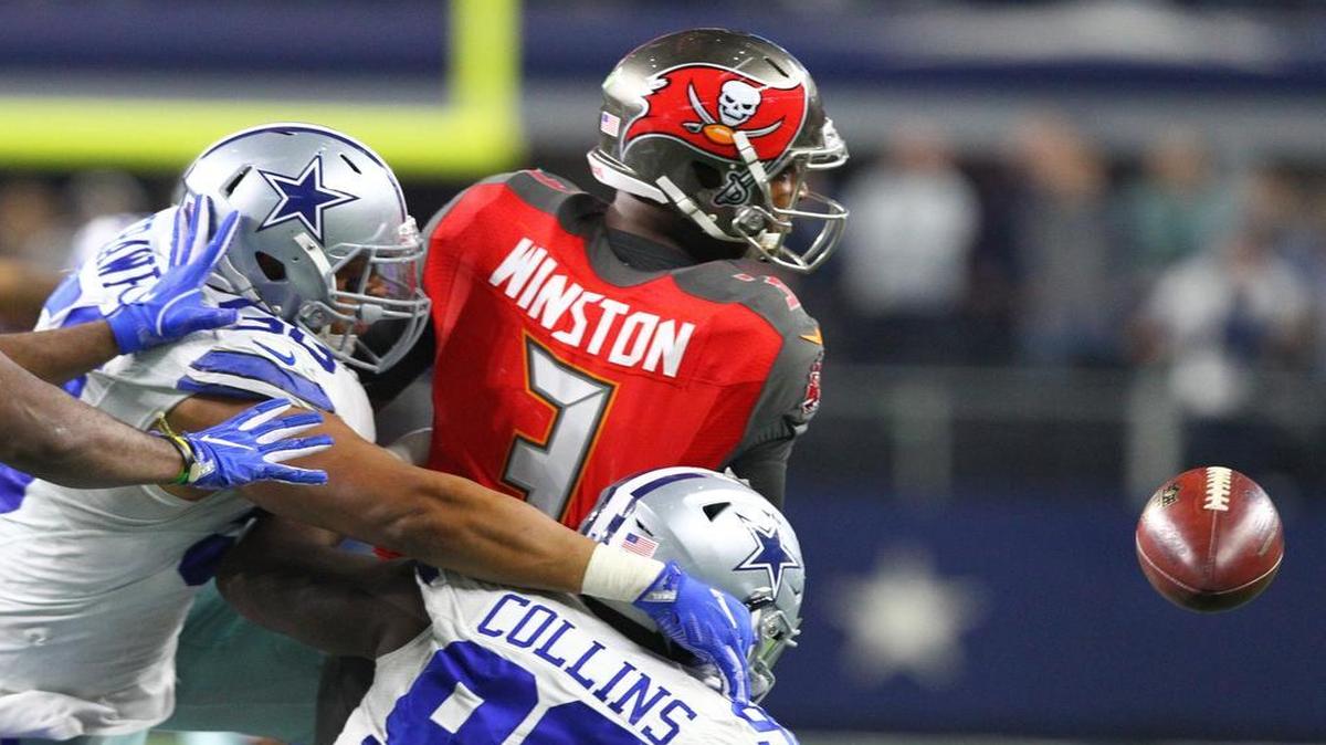 Cowboys defensive end Jack Crawford, left, and defensive tackle Maliek Collins hit Buccaneers quarterback Jameis Winston during the fourth quarter Sunday.