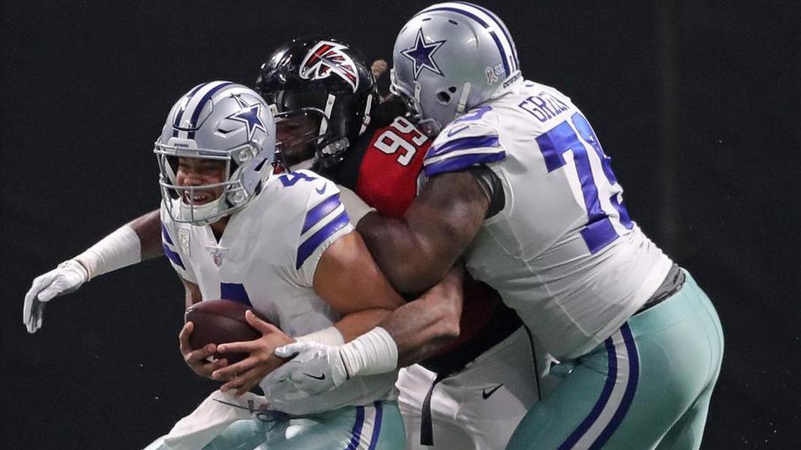Former Cowboys backup tackle Chaz Green, right, didn’t provide much resistance a year ago in a 27-7 loss to the Atlanta Falcons against defensive end Adrian Clayborn tries to wrap up quarterback Dak Prescott. Prescott was sacked eight times, including six by Clayborn.