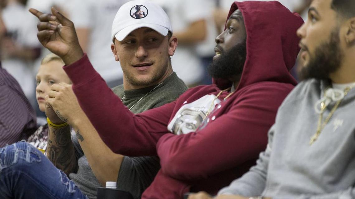Former Heisman Trophy winner Johnny Manziel, left, attended Texas A&M’s basketball game with former teammates Sean Porter, center, and Mike Evans on Saturday.