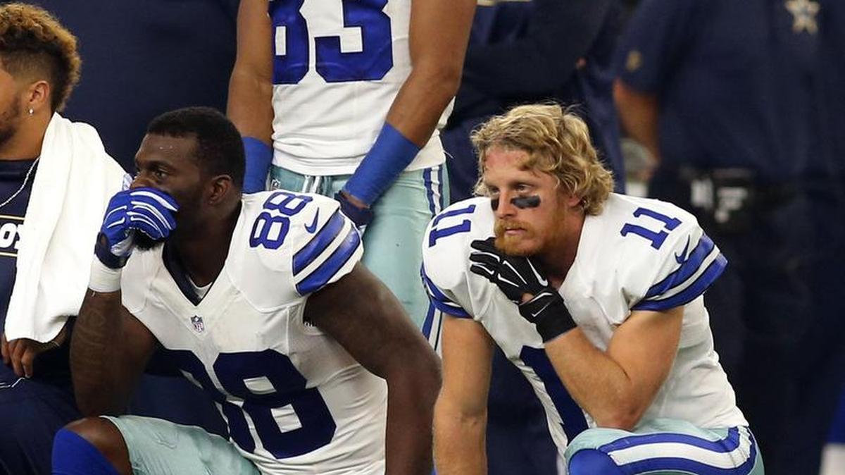 Dallas Cowboys wide receivers Dez Bryant (88), Terrance Williams (83), Cole Beasley (11) take a knee as an injured Seattle Seahawks player is attended to in the 2nd quarter at AT&T Stadium Sunday.