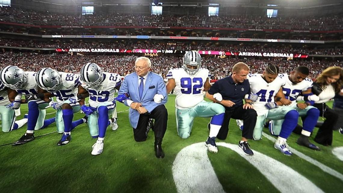 Jerry Jones and the Cowboys take a knee before the national anthem was sung before Monday night’s game against the Arizona Cardinals at University of Phoenix Stadium in Glendale, Ariz.