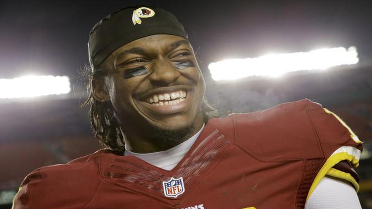 
Washington Redskins quarterback Robert Griffin III (10) smiles on the sidelines after an NFL football game against the Philadelphia Eagles in Landover, Md., Saturday, Dec. 20, 2014. The Redskins defeated the Eagles 27-24. 
