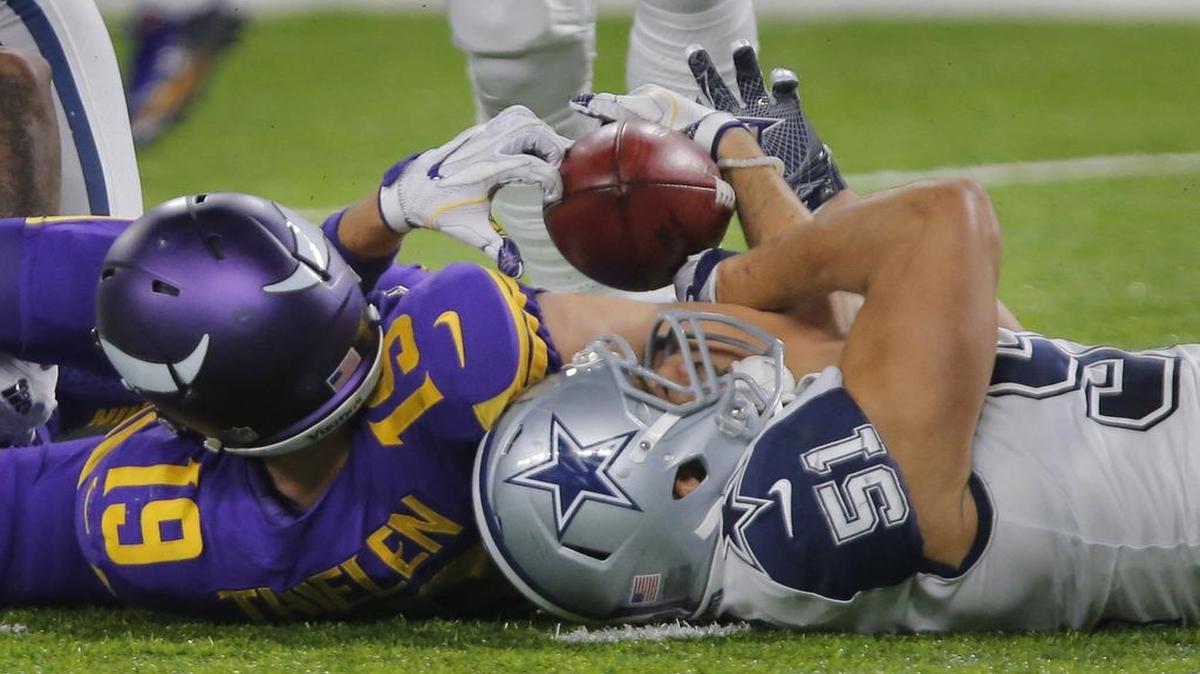 Cowboys linebacker Kyle Wilber, right, recovered a fumbled punt by Vikings receiver Adam Thielen. The takeaway was the first in five games for the Cowboys.