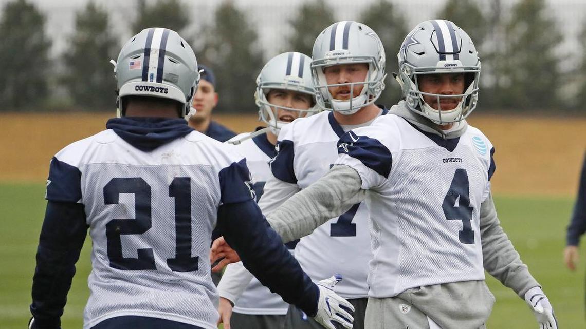 Dallas Cowboys quarterbacks Dak Prescott (4) and Cooper Rush (7) greet running back Ezekiel Elliott (21), who returned to practice at The Star in Frisco after a six week suspension.