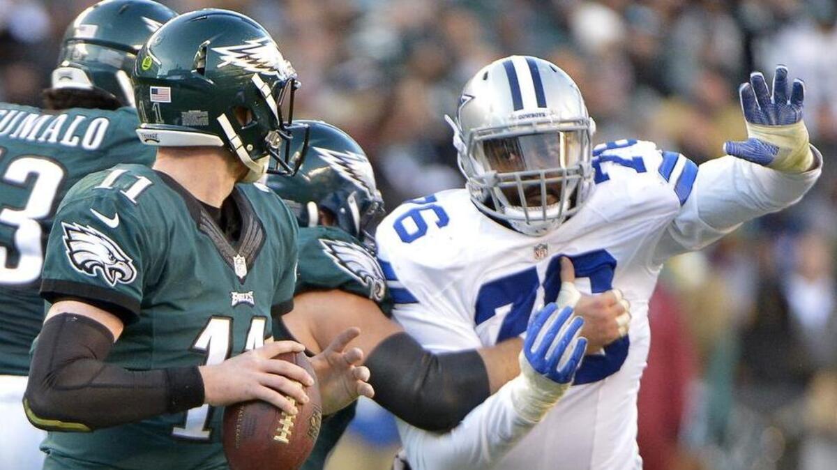 Richard Ash, right, played in one game for the Cowboys last season.