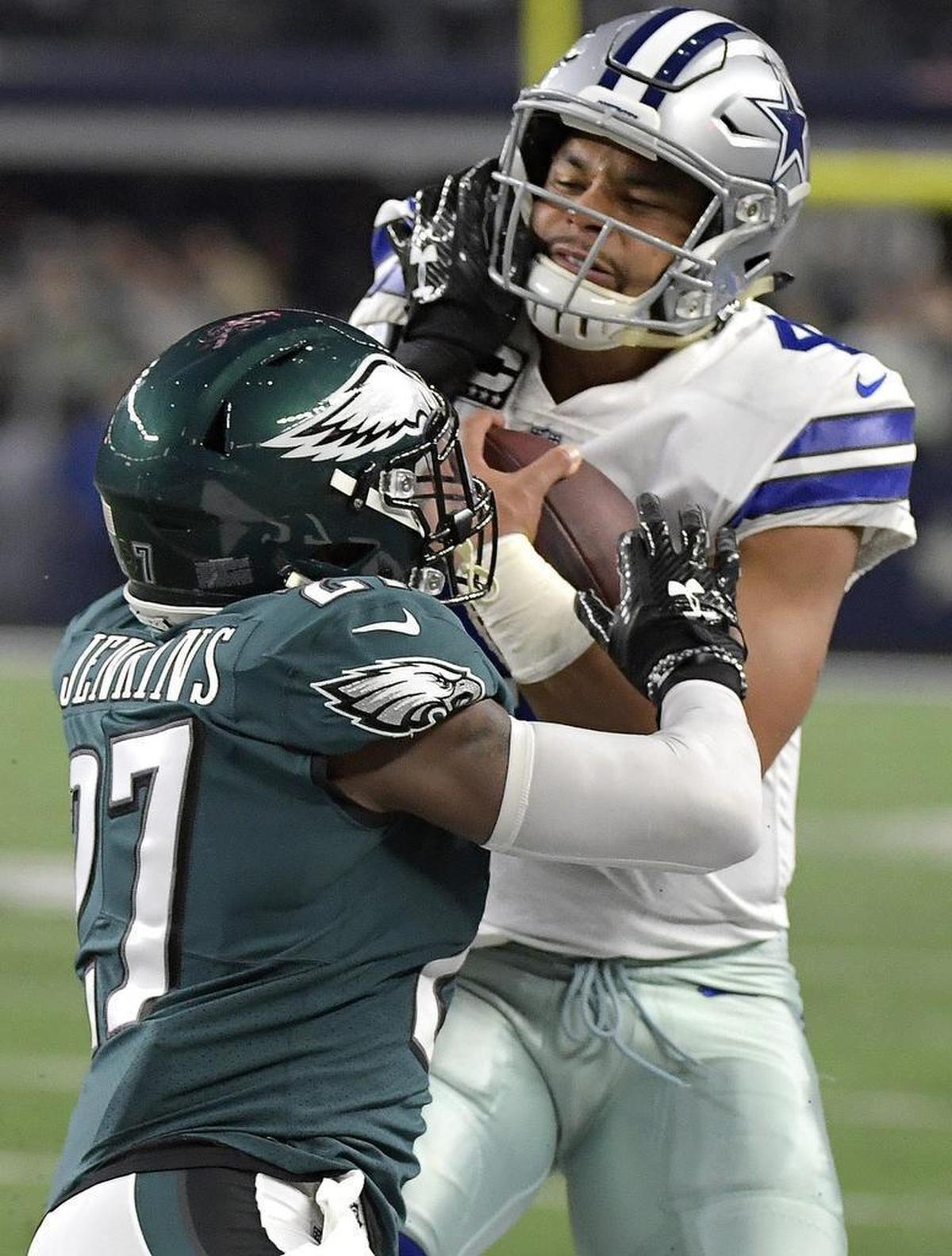 Dallas Cowboys quarterback Dak Prescott (4) stiff-arms Philadelphia Eagles strong safety Malcolm Jenkins (27) to pick up a first down during the first quarter as the Cowboys play the Eagles at AT&T Stadium in Arlington Sunday, Nov. 19.