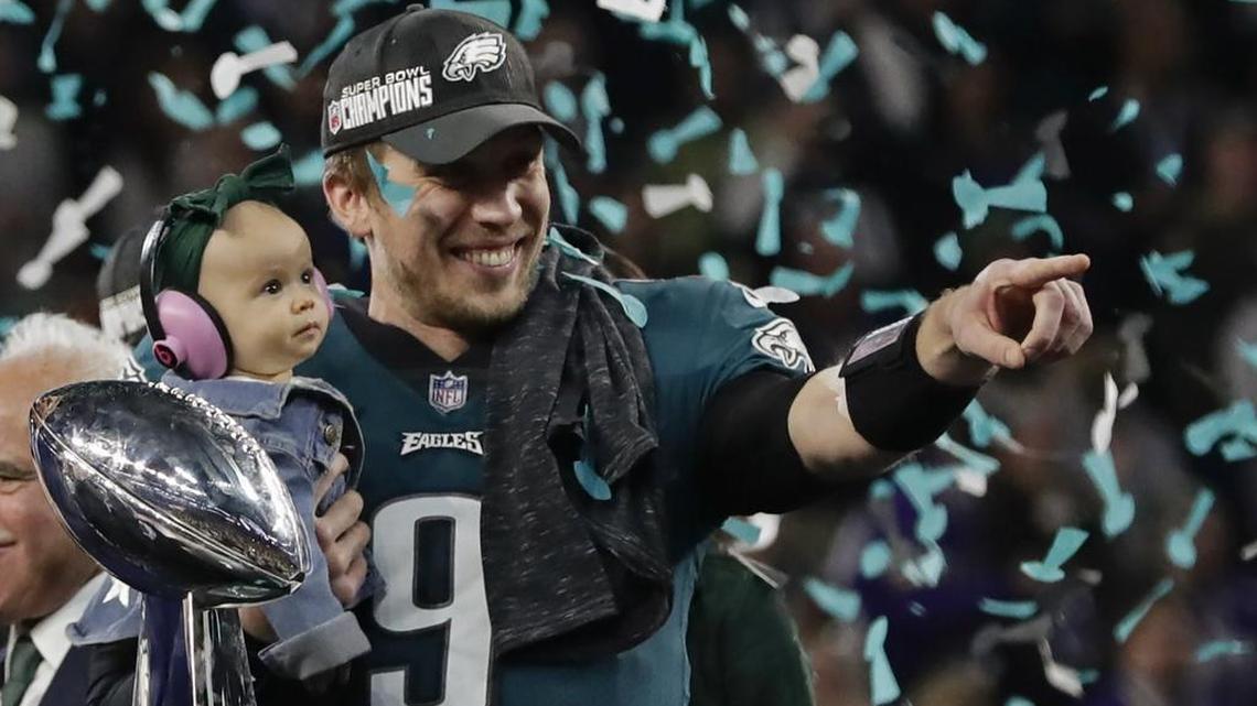 Philadelphia Eagles quarterback Nick Foles (9) holds his daughter, Lily James, after winning the NFL Super Bowl 52 football game against the New England Patriots, Sunday, Feb. 4, 2018, in Minneapolis. The Eagles won 41-33.