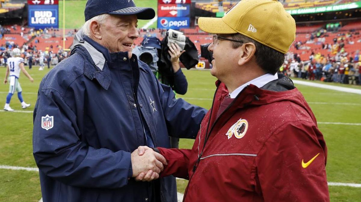 Dallas Cowboys owner Jerry Jones and Washington Redskins owner Dan Snyder talk before Sunday’s game. On Tuesday, the Redskins' president of business operations, Dennis Greene, resigned.