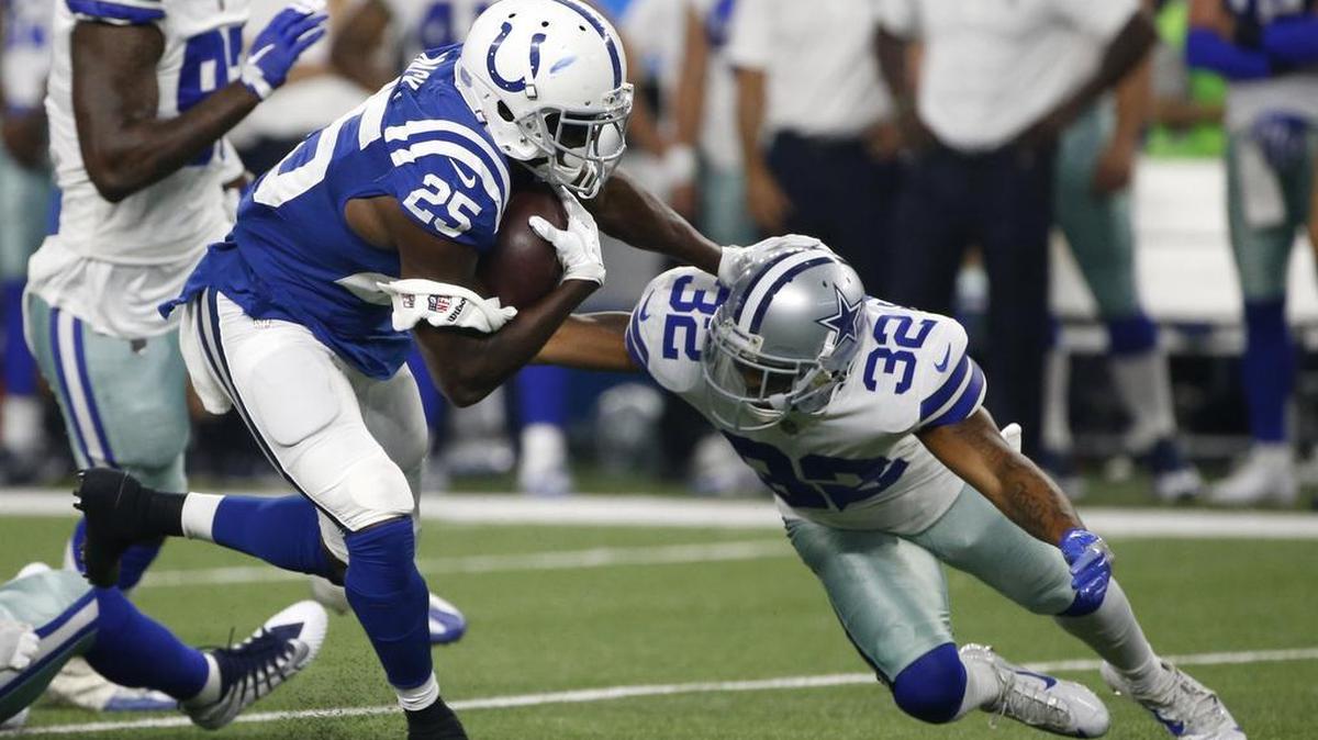 Indianapolis Colts running back Marlon Mack runs the ball as Cowboys cornerback Orlando Scandrick attempts the tackle in the first half of a preseason NFL football game Saturday.