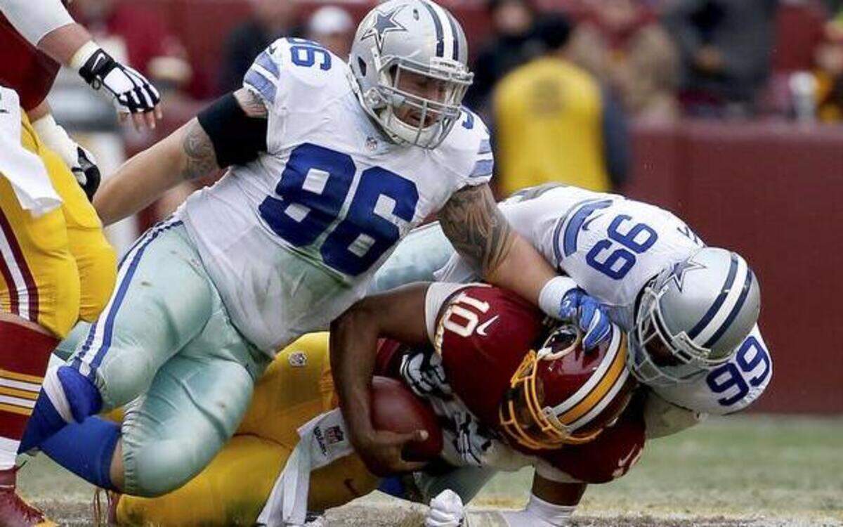 
Redskins QB Robert Griffin III, center, is sacked by Dallas Cowboys DT Nick Hayden, left, and DE George Selvie, right. Dallas defense forced three turnovers for the third consecutive game. 



