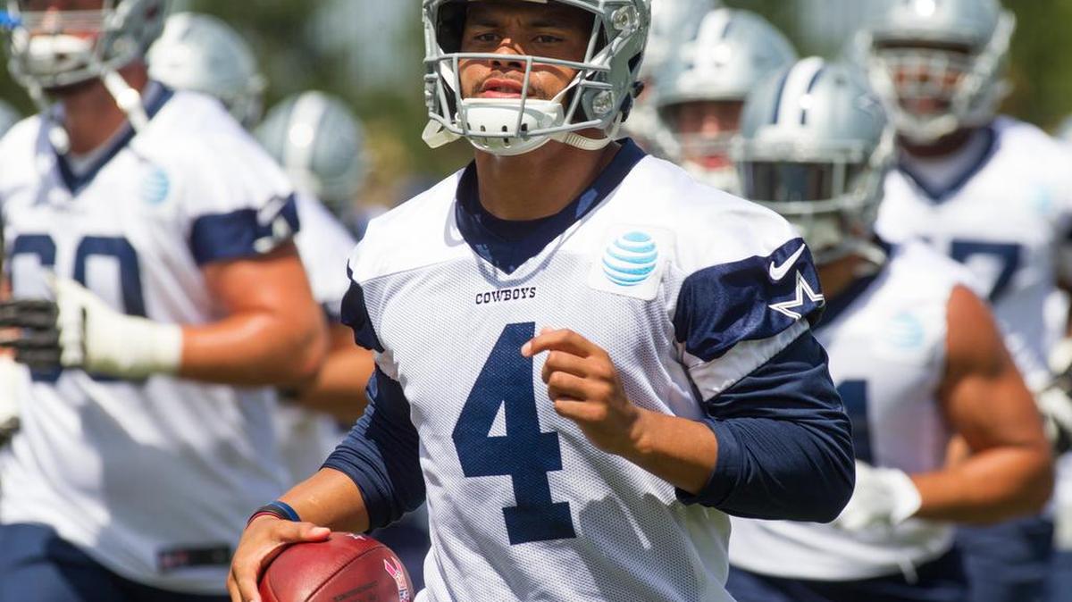 Dallas Cowboys quarterback Dak Prescott jogs onto the practice field as the Cowboys opened minicamp in Frisco at The Star on Tuesday, June 13, 2017.