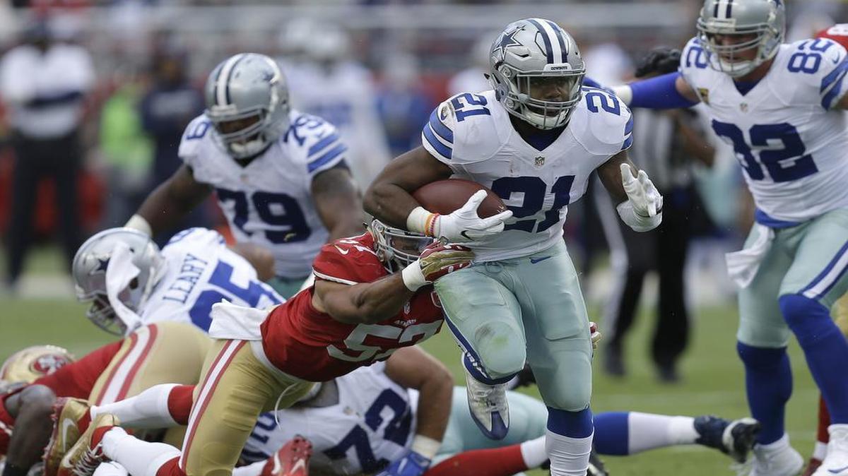 Dallas Cowboys running back Ezekiel Elliott (21) runs in front of San Francisco 49ers linebacker Michael Wilhoite during the first half Sunday in Santa Clara, Calif. Elliott rushed for 138 yards and one touchdown in the Cowboys’ 24-17 victory.