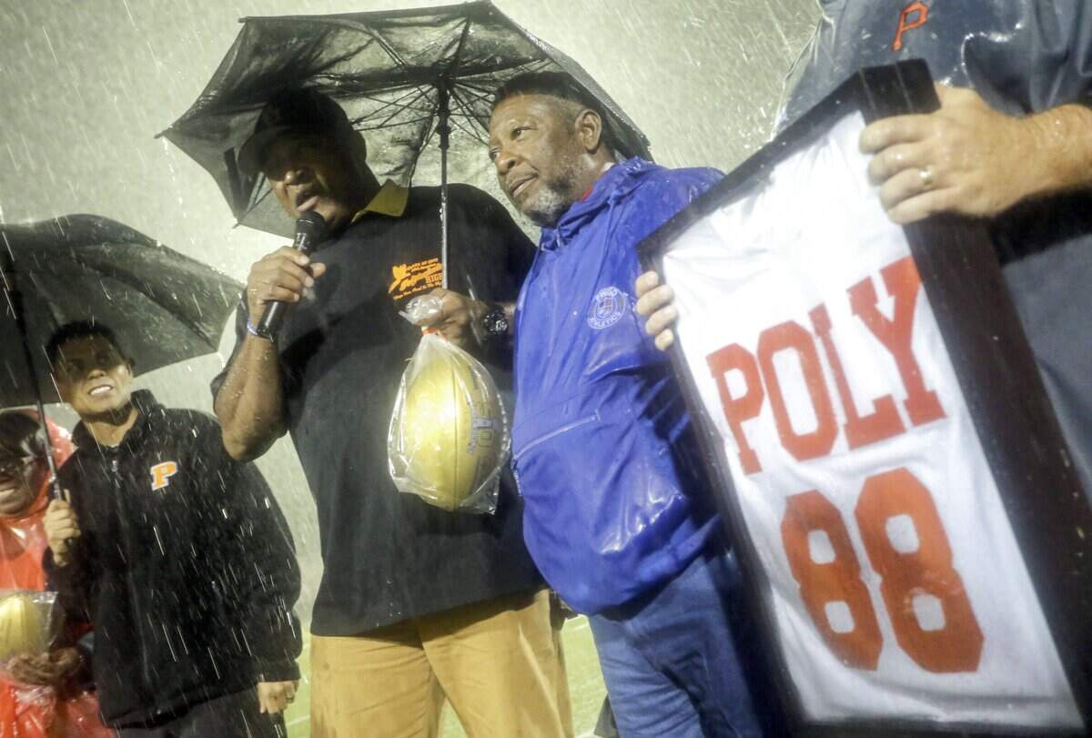 Former NFL player Greg Hawthorne (left with microphone) speaks at a halftime presentation during the Fort Worth Polytechnic-Eastern Hills game on Thursday, Oct. 22, 2015.