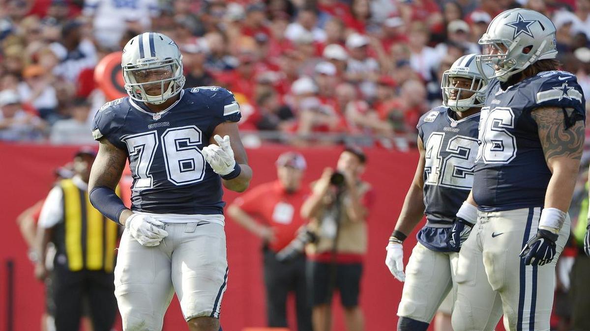 Dallas Cowboys defensive end Greg Hardy (76) plays the air guitar to the chagrin of the Tampa Bay Buccaneers fans during a break in the fourth quarter as the Buccaneers beat the Cowboys 10-6 at Raymond James Stadium in Tampa, FL.