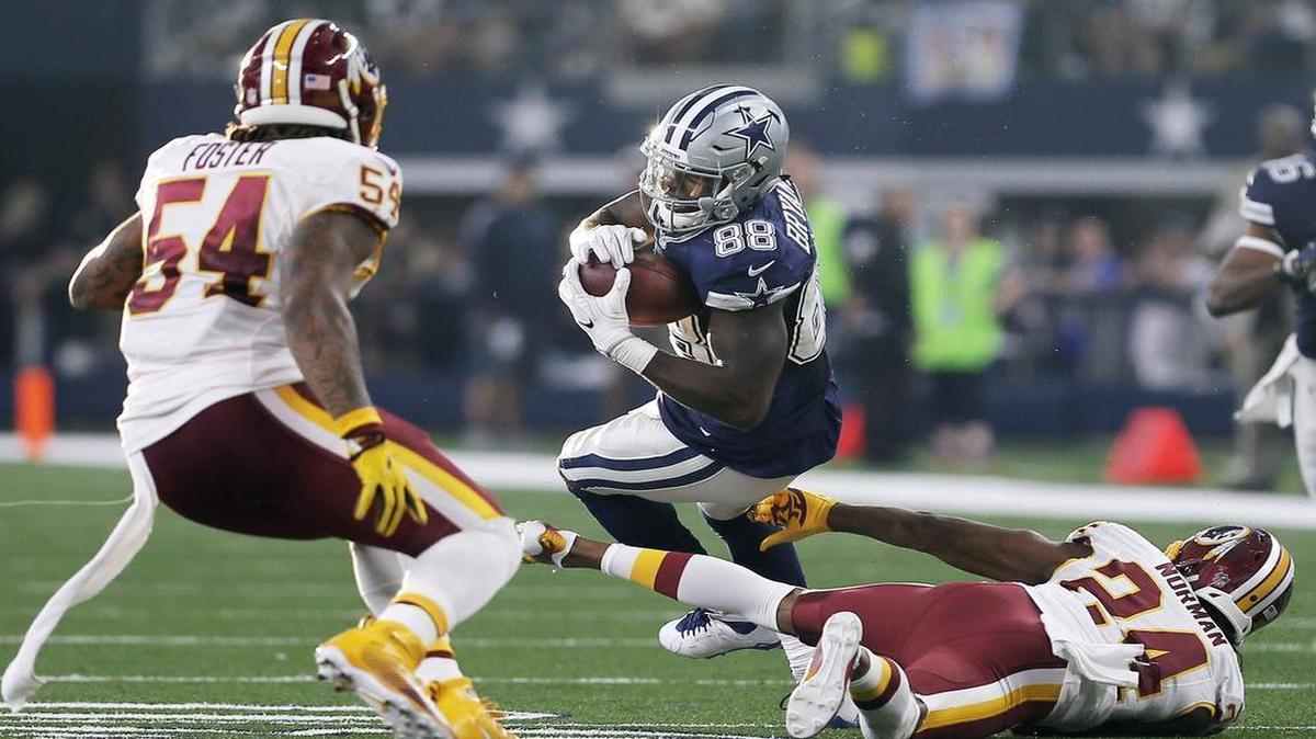 Dallas Cowboys wide receiver Dez Bryant breaks a tackle by Washington Redskins cornerback Josh Norman on one of his five receptions Thursday at AT&T Stadium.